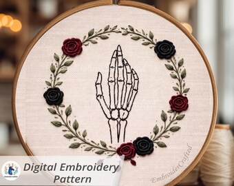 May include: A digital embroidery pattern featuring a skeletal hand in the center, surrounded by a wreath of green leaves and red and black roses. The design is set in a wooden embroidery hoop. The text "Digital Embroidery Pattern" is visible.