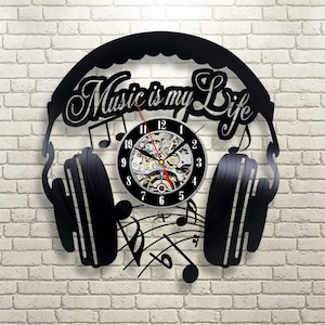 May include: Black vinyl record clock with headphones and music notes. The clock face says "Music is my Life".