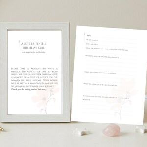 May include: A white framed sign and a matching card titled A Letter to the Birthday Girl, to be opened on her 18th birthday. The card features lines for writing a message, a memory, or advice, decorated with a faint pink floral illustration.