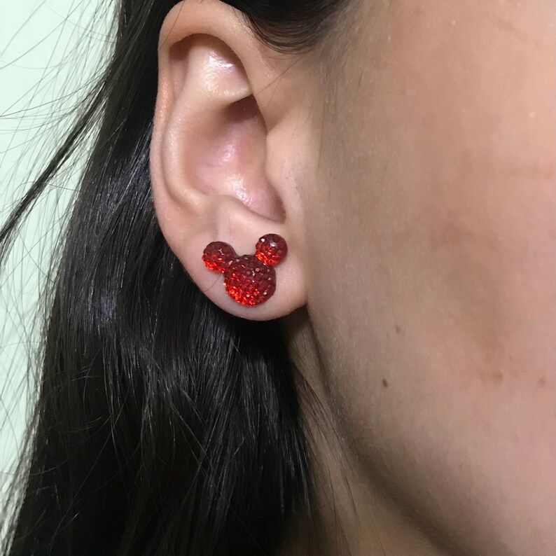 Puede incluir: Pendientes de Mickey Mouse de strass rojo. Los pendientes son peque&ntilde;os y presentan una silueta cl&aacute;sica de Mickey Mouse.