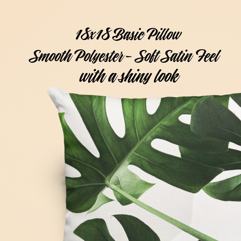 May include: A white pillow with a green tropical leaf print. The pillow is 18x18 inches and made of smooth polyester with a soft satin feel.