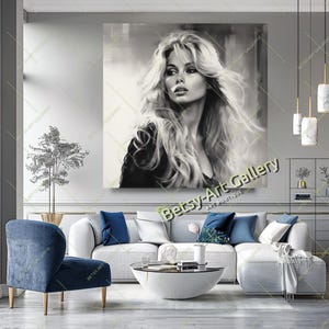May include: Black and white portrait art print of a woman with long, flowing blonde hair. The artwork is displayed on a wall above a white sectional sofa with blue accent pillows. The text "Betsy-Art Gallery" is visible.