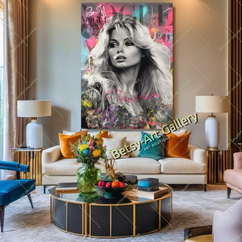 May include: A large, framed artwork featuring a black and white portrait of a woman with blonde hair, set against a vibrant, colorful background. The word "Vogue" is visible at the top. The artwork hangs above a white sofa with colorful pillows, a coffee table, and lamps.