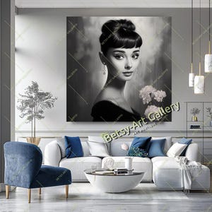 May include: Black and white portrait of a woman with dark hair in a bun, wearing a black dress and dangling earrings, holding white flowers. The artwork is displayed on a wall in a living room setting. The text "Betsy Art Gallery" is visible.