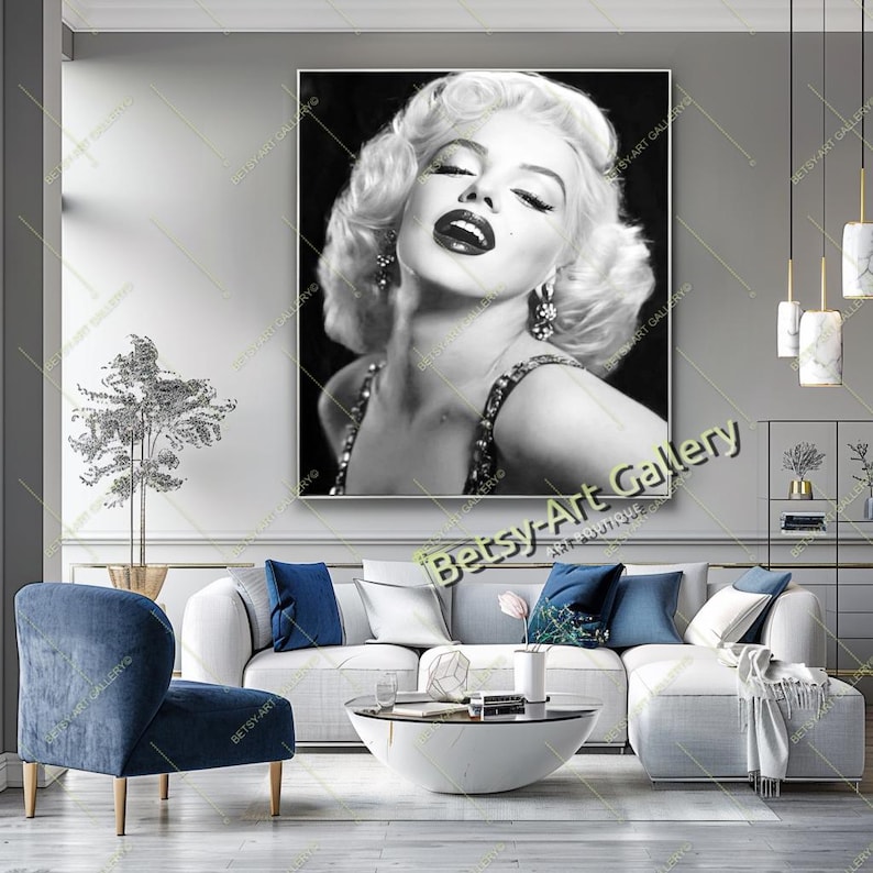 May include: Black and white portrait of Marilyn Monroe with her eyes closed and lips parted. She is wearing a beaded necklace and earrings. The artwork is displayed in a living room setting.