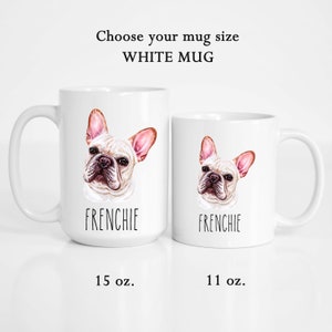 May include: Two white ceramic mugs with a French Bulldog design. The mugs feature a watercolor illustration of a Frenchie's face, with the word "FRENCHIE" below. The larger mug is 444 ml, and the smaller is 325 ml. Text at the top reads "Choose your mug size WHITE MUG".