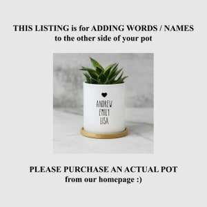 May include: White ceramic planter with a wooden base. The planter has a black heart and the names Andrew, Emily, and Lisa written on it. The planter is shown with a small succulent plant.