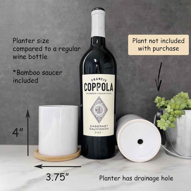 a bottle of coppola next to a cup and a plant