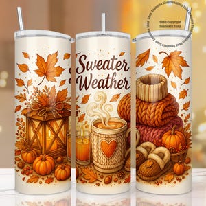 May include: A set of three insulated tumblers with fall-themed designs. Each tumbler features a white background with illustrations of pumpkins, autumn leaves, a lantern, a mug of coffee, and a stack of sweaters. The text "Sweater Weather" is displayed on one tumbler.
