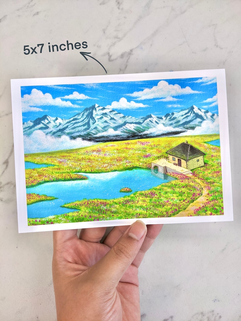 May include: A watercolour painting of a small house with a blue roof, nestled in a green field with a blue lake. The house is surrounded by mountains in the background, and the sky is blue with white clouds.
