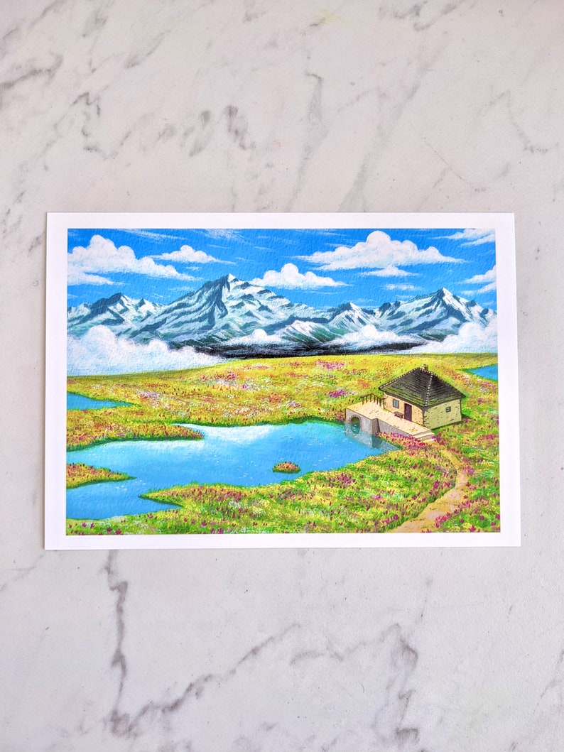 May include: A painting depicting a small cottage with a brown roof and a blue door, set in a field of green grass and pink flowers. The cottage is close to a small blue lake, with a mountain range in the background. The sky is blue with white clouds.