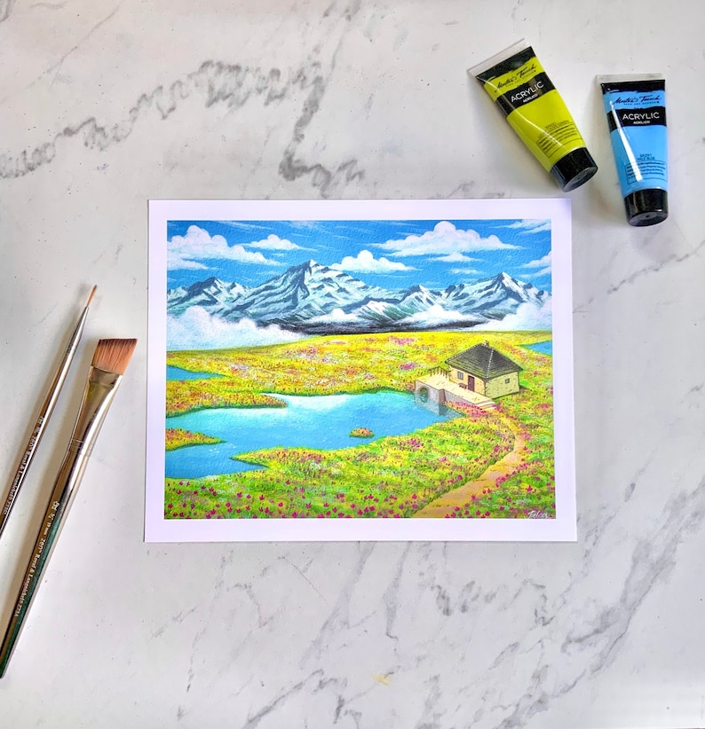 May include: A colourful painting depicting a small house with a lake and mountains in the background. The house is green and white with a brown roof. The lake is blue and surrounded by green grass and flowers. The mountains are white and covered in snow. The sky is blue with white clouds.