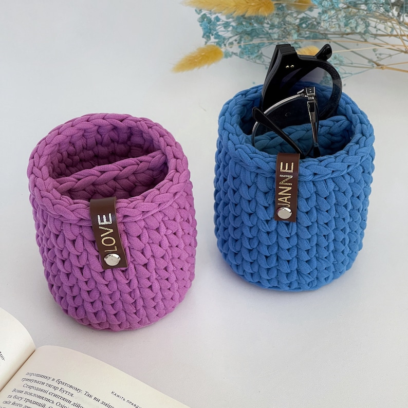 Main view of a soft vertical eyeglass holder stand with two compartments, safely holding two pairs of glasses upright.