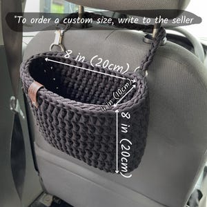 In the photo is a basket crocheted from t-shirt yarn, which can be hung on the headboard of the car seat. The strap is attached with a strong metal button. Suitable for collecting small trash or for storing napkins, water or other personal items.