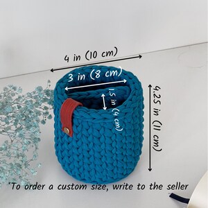 ⁠A hand holding the compact vertical glasses organizer to display its real-life scale and dimensions.