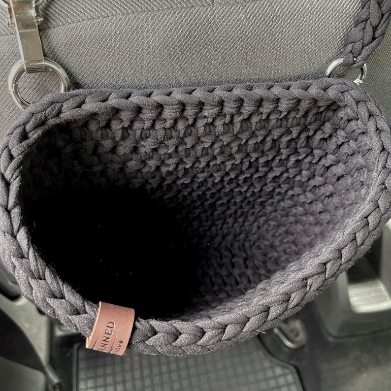 In the photo is a basket crocheted from t-shirt yarn, which can be hung on the headboard of the car seat. The strap is attached with a strong metal button. Suitable for collecting small trash or for storing napkins, water or other personal items.
