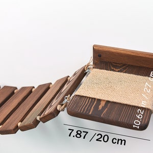May include: A wooden cat bridge with a sisal-covered platform. The bridge is 7.87 inches (20 cm) long and the platform is 10.62 inches (27 cm) wide.