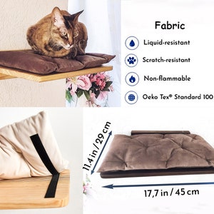 May include: A brown cat bed with a brown cushion and a wooden shelf. The bed is 11.4 inches by 29 centimeters and the shelf is 17.7 inches by 45 centimeters. The fabric is liquid-resistant, scratch-resistant, non-flammable, and Oeko-Tex Standard 100 certified.