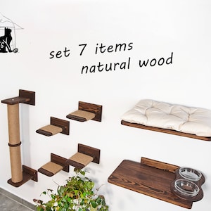 May include: Set of 7 natural wood cat furniture items, including a scratching post, shelves, and a bed. The set is mounted on a white wall.