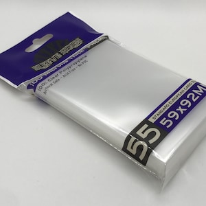 May include: A pack of 55 clear card sleeves. The packaging has a blue and white header with the text "SLEEVE KINGS". The sleeves are 5.9cm x 9.2cm and made of clear polypropylene, archival safe, and acid-free.