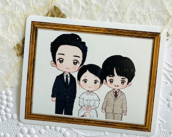 May include: A framed illustration of a family portrait with three people. The father is wearing a black suit and tie. The mother is wearing a white dress with a ruffled collar. The child is wearing a brown suit with a white shirt and tie. The frame is gold with a white mat.
