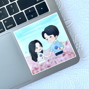 May include: A cartoon illustration of a couple holding hands in a field of pink flowers. The man is wearing a blue shirt and the woman is wearing a white dress. They are both smiling.