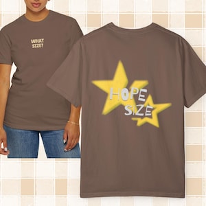Puede incluir: Una camiseta marrón con el texto "What Size?" en la parte delantera y el texto "Hope Size" dentro de dos estrellas amarillas en la parte posterior.
