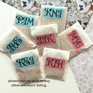 May include: Eight small white paper envelopes with different colored labels. Each label has a different three-letter monogram in black. The monograms are: PIM, KNI, JIK, MYG, IJS, KSI, and KIH. The text "please visit my shop to buy other members' listing." is printed below the envelopes.