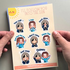 May include: A sticker sheet titled I'll Follow You Into The Sun featuring eight cartoon character illustrations. Each character is paired with text including You call, I run, Dark days, And find the sun, I don't care, How far, Just wait, and Dawn.