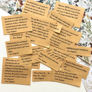May include: A collection of brown paper cards with inspirational quotes written in black ink. The quotes are attributed to "Jeon Jungkook".
