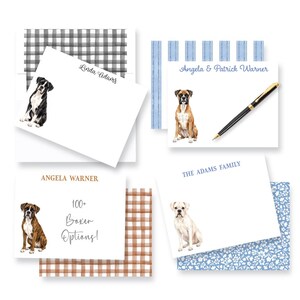 May include: Four white stationery note cards featuring watercolor illustrations of Boxer dogs. The cards display names like Linda Adams, Angela & Patrick Warner, and The Adams Family, with one card stating 100+ Boxer Options! and a black pen.