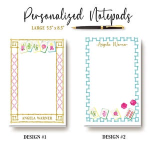 May include: Two personalized notepads, each 5.5" x 8.5", with unique designs. One features a gold and pink bamboo-style border with Mahjong tiles and the name "Angela Warner." The other has a turquoise border, Mahjong tiles, and dice, also with the name "Angela Warner."