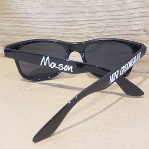 May include: Black sunglasses with the text "Mason" on one side and "Mini Groomsman" on the other side.