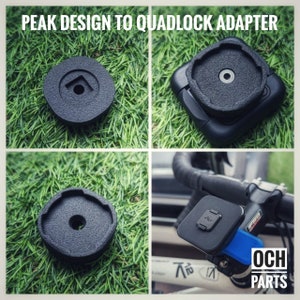 May include: Black plastic adapter for attaching a Peak Design camera plate to a Quadlock phone mount. The adapter is shown on a green grassy surface and attached to a bicycle handlebar.