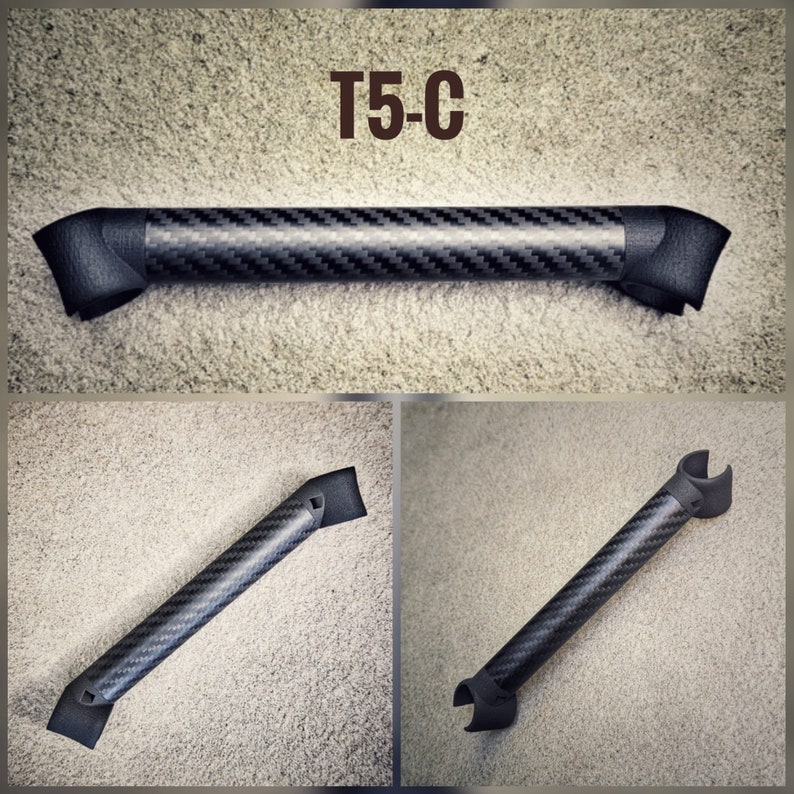May include: A black carbon fiber grab handle with a T5-C label. The handle has a curved shape and is designed for use in a vehicle.