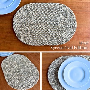 May include: A set of three oval placemats made from woven natural fibre. The placemats are beige and have a subtle braided pattern. The placemats are 18 inches by 12 inches and are labelled "Special Oval Edition".