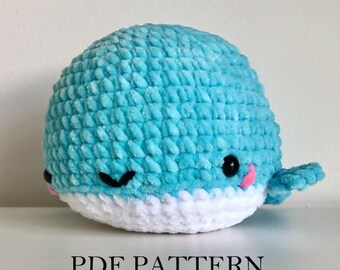 May include: A handmade, plush, turquoise whale with a white belly, black eyes, and a pink mouth. The whale has small fins and a rounded shape. The text "PDF PATTERN" is at the bottom of the image.