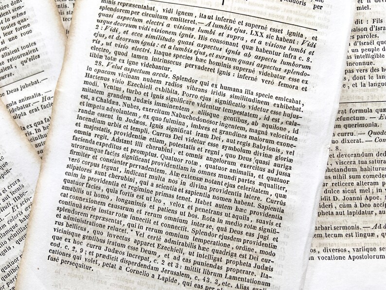 May include: Antique book pages with Latin text. The open book displays columns of small print, with visible aging and texture. The pages are yellowed, and the text is in black ink.