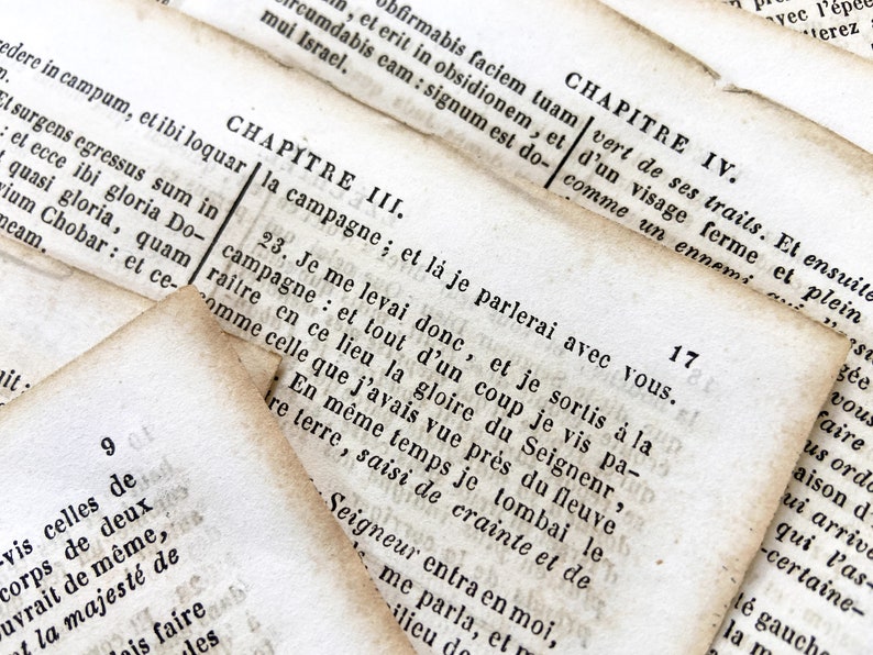 May include: Close-up of aged book pages with French text. The pages are yellowed and worn, with visible text from chapters III and IV. The image highlights the texture and age of the paper, creating a vintage aesthetic.