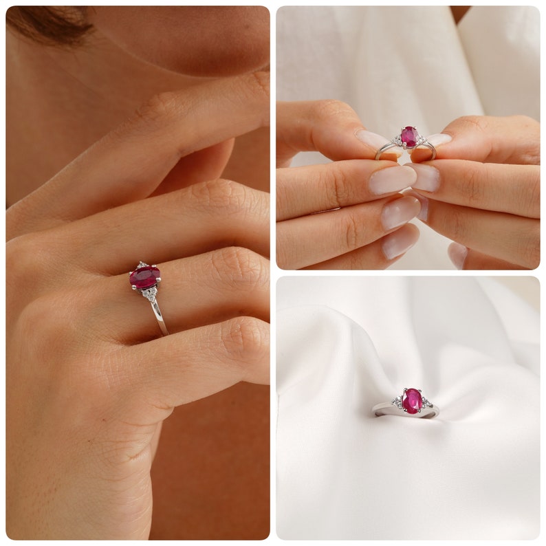 Puede incluir: Un anillo de plata con una piedra ovalada roja y dos piedras blancas m&aacute;s peque&ntilde;as a cada lado.