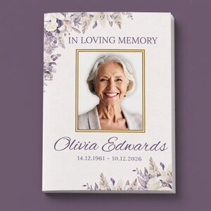 May include: A funeral programme booklet featuring a portrait of an older person with white hair inside a gold frame. The text reads IN LOVING MEMORY, Olivia Edwards, and the dates 14.12.1961 - 10.12.2026, decorated with purple floral illustrations.