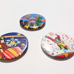 Vintage 80’s Transformers Badges, Retro Cartoon Buttons, Eighties TV pins.