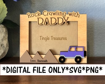 May include: A wooden picture frame with the text "Rock-Crawling-with DADDY" and "Tingle Treasures" on it. The frame has a cutout of a purple jeep with black wheels and brown mountains. The text "Love, Hannah" is at the bottom of the frame.