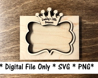 May include: A wooden frame with a crown design and the text "Daddy's Little Princess". The frame has a decorative border and is made of light-colored wood. The image also includes the text "Digital File Only * SVG * PNG*".