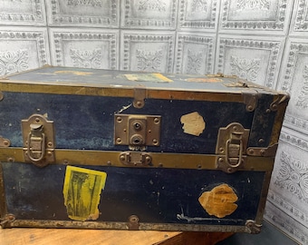 Vintage travel trunk suitcase with travel stickers child doll