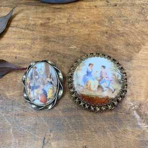 Set of 2 vintage porcelain brooches with Victorian courting painted scenes