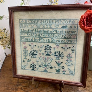 vintage cross stitched sampler 1994 framed France signed M Bryant 17.5” x 9”