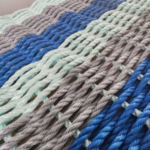 Rope Mat made with Lobster Rope 6 Stripe. Blue gray and seafoam