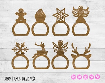 Puede incluir: Conjunto de diez anillos de servilleta con temática navideña, cada uno con un diseño diferente, que incluye un hombre de jengibre, un copo de nieve, un reno, un árbol de Navidad y un ángel. Los anillos están hechos de madera y están diseñados para ser utilizados como anillos de servilleta.