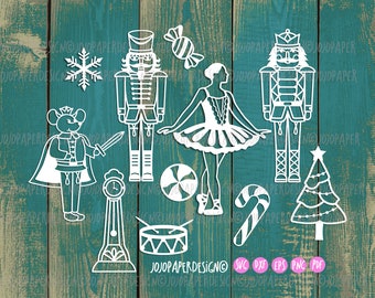 May include: White paper cutouts of a nutcracker, a ballerina, a mouse king, a Christmas tree, a clock, a drum, candy canes, and snowflakes. The cutouts are on a teal wood background. The text "JOJOPAPERDESIGNO SVC DXF EPS PNC PDF" is at the bottom of the image.